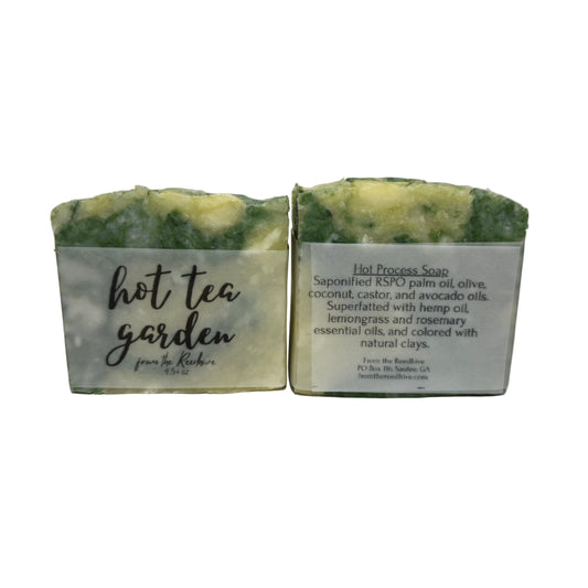 Two green and white soap bars with text on a light gray background