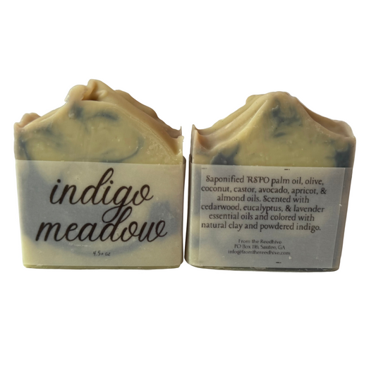 Two bars of 'indigo meadow' soap with labels on a light background